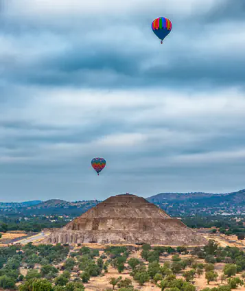 hot air balloon above Teotihuacan pyramids